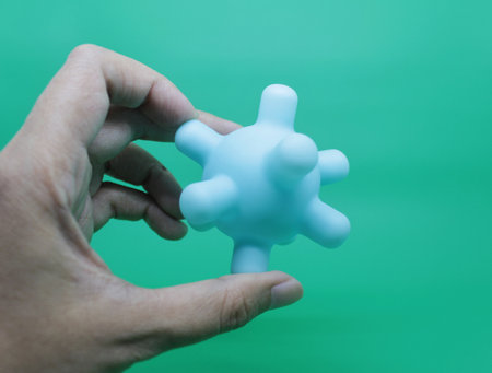colorful baby rattles or teethers isolated on green background, to stimulate the growth of baby teeth.の写真素材