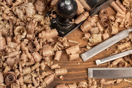 Chisel and small block plane with wood shavings