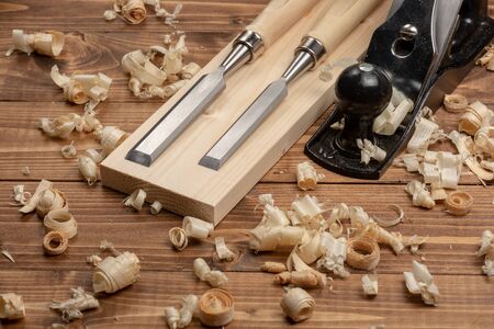 Chisel and metal planer with wood shavings