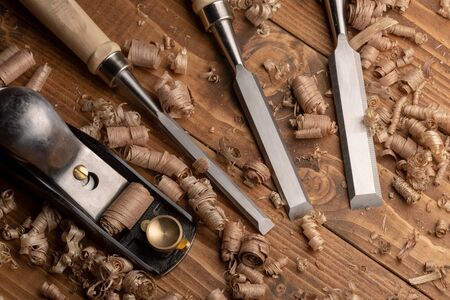 Chisel and small block plane with wood shavings
