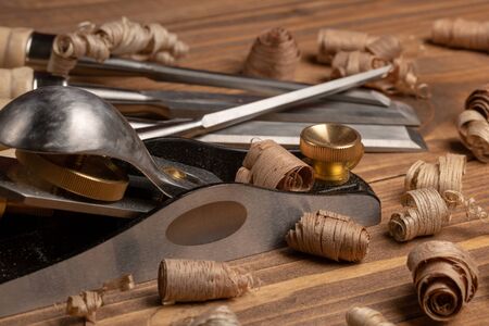 Chisel and small block plane with wood shavings