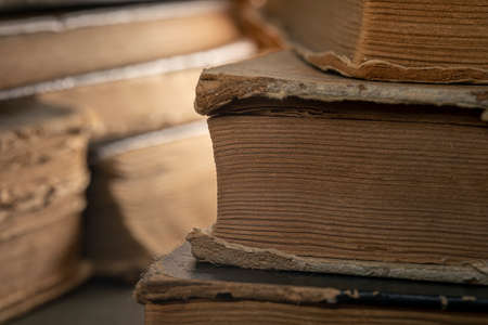 Stacks of old multi-format books with scuffs. Low depth of field photographyの写真素材