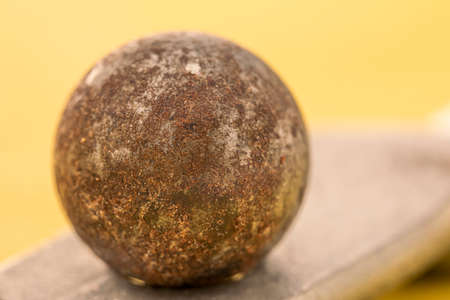 Closeup of a rusty ball bearing on a copper plate. Low depth of field photographyの写真素材