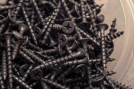 A handful of self-tapping screws for wood. Construction abstraction. Industrial background.の写真素材