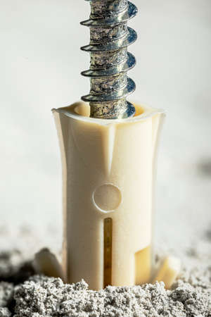 Drilled hole in concrete with screw dowel. Plastic dowel for screws.の写真素材