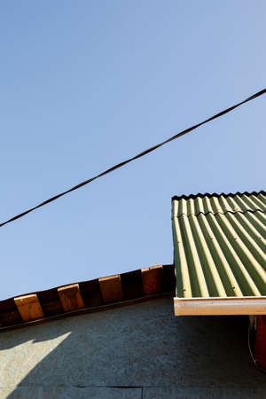 House wall from OSB slabs against the blue sky. Abstract art photography.