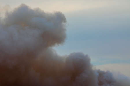 Swirling smoke from a large fire, similar to clouds. Cumulus clouds.