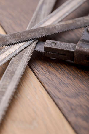 Old vintage metal hacksaw blade close up. Background for craftsmanship and manual labor.の写真素材
