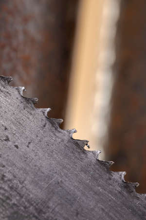 Old vintage metal hacksaw blade close up. Background for craftsmanship and manual labor.の写真素材