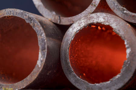 Background of fragments of rusted metal pipes close-up. Industrial abstract background.の写真素材