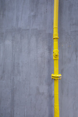 A minimalistic composition of a metal pipeline and a wall.の写真素材
