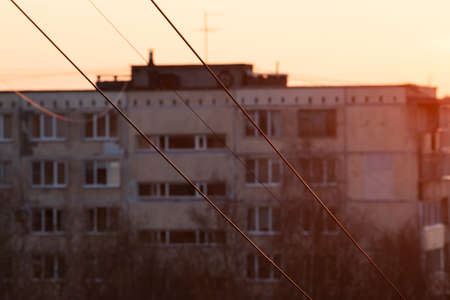 Communication wires between panel houses at sunset. Sleeping Districts of Soviet construction.の写真素材