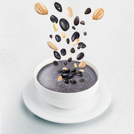 Bowl of black seasame milk mix more cereal on white background