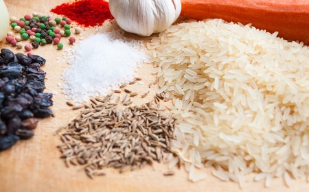 Products for cooking pilaf lie on a wooden backgroundの写真素材