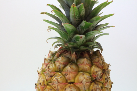 Ripe pineapple isolated on whiteの写真素材