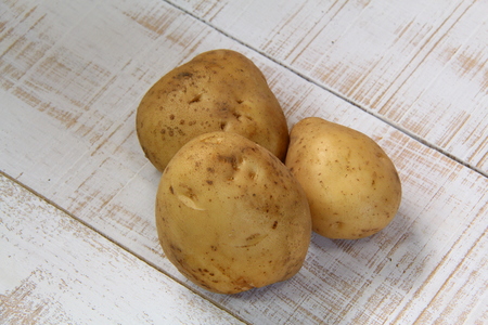 Three potatoes on white Backgroundの写真素材