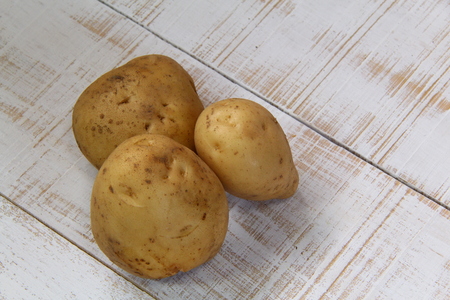 Three potatoes on white Backgroundの写真素材