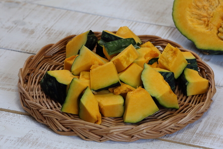 Fresh diced Pumpkin in bamboo basket.の写真素材