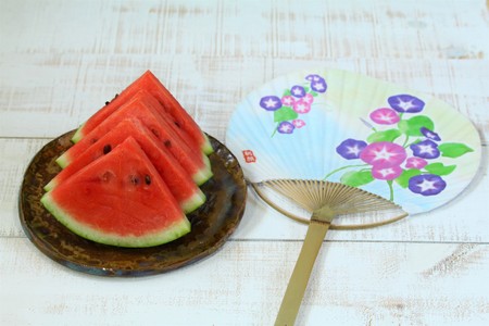 Summer image, watermelon and a fanの写真素材