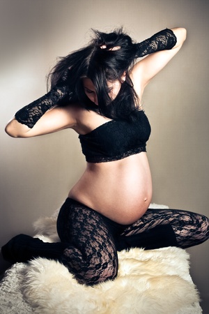 pregnant woman in lacy stockingsの写真素材