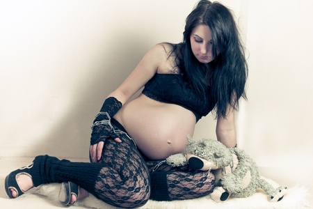 pregnant woman with teddy another in a chainの写真素材