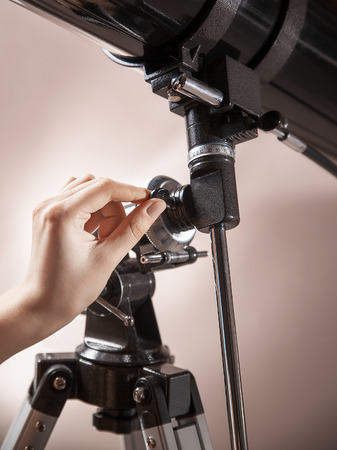 man adjusts a telescope closeup.の写真素材