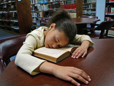Child fell asleep while studying.の写真素材