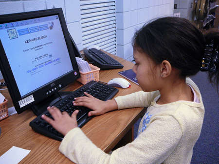 Child using library computer.