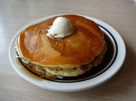 Stack of pancakes with butter and syrupの写真素材