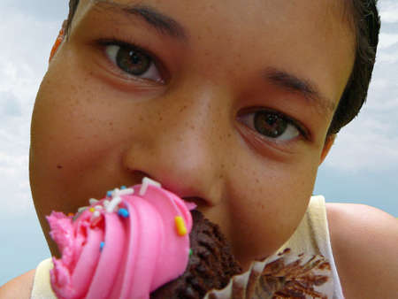 Child eating cupcakeの写真素材