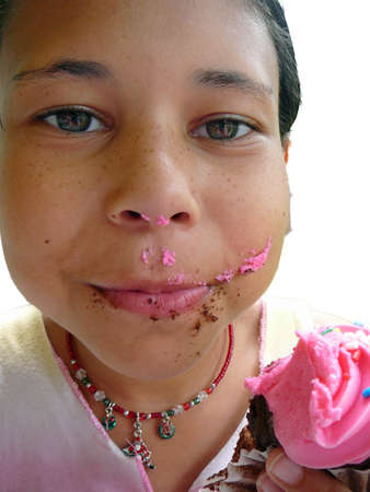 Child eating cupcakeの写真素材