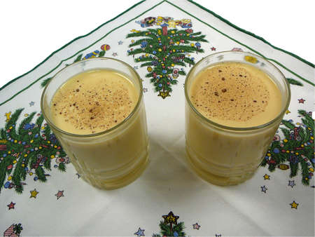 Two glasses of egg nog on a Christmas napkinの写真素材