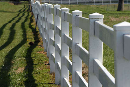 Rail fence with shadowsの写真素材