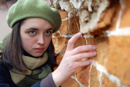 Girl near the wallの写真素材