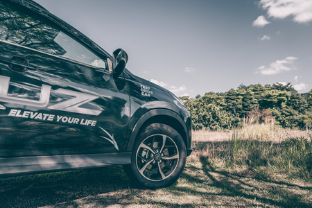 Putrajaya, Malaysia - February 17, 2019: New car perodua aruz exterior design on a green field on a...