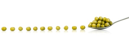 Preserved peas in spoon isolated on white backgroundの写真素材