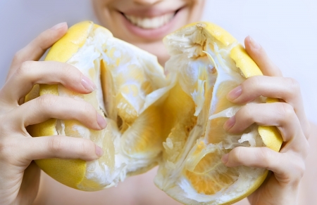 Smiling girl holding  pomeloの写真素材