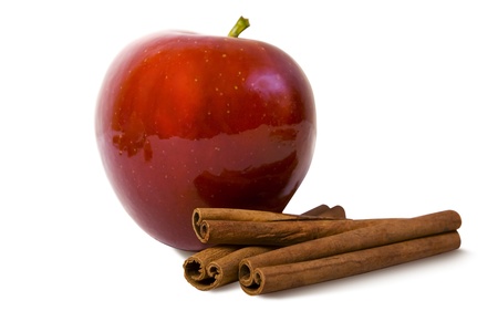 apple with cinnamon rods isolated on whiteの写真素材