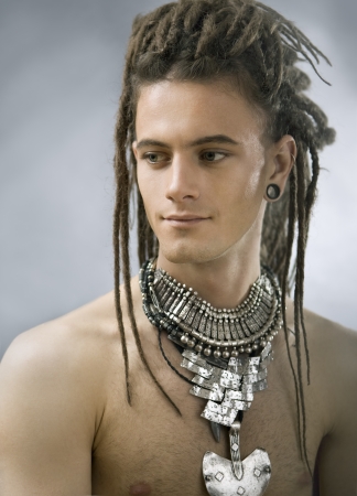 Stylish handsome guy with dreadlocks and jewelryの写真素材