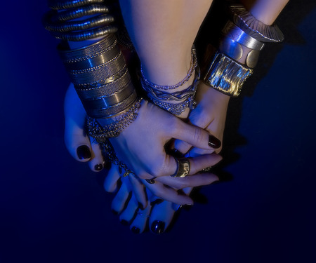 oriental jewelry: female feet and hands with beautiful national indian jewellery, tribal style (blue...