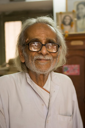 VARANASI, INDIA, Jan 9, 2015: Unidentified indian old Man in his Book Shop (library) on Jan 9, 2015,...