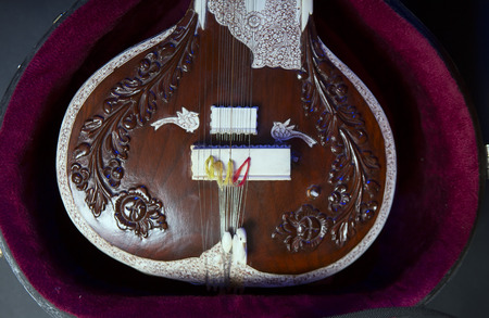 Sitar, a String Traditional Indian Musical Instrument, close-up, blue lens effect. dark background....
