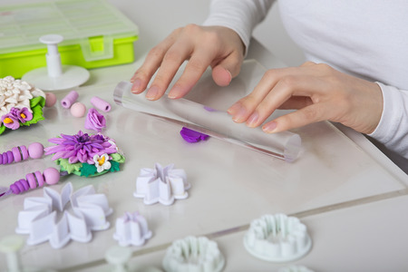 Artist makes jewelry from color Polymer Clay, artist at work. Workshop. Hobby – Art Clay Modeling....