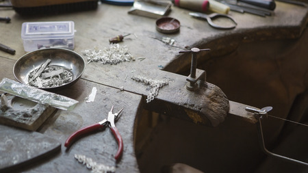 Indian Jeweler making an Oriental Jewelry in workshop. Handmade traditional jewel Manufacturing in Jaipur (Rajasthan). Jewelry Manufacturing Process in India. Indian Silver and Gold Jewel and Gemsの写真素材