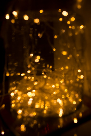 Golden lights. Abstract blurred Background. Festive lights close-up in the New Year Decor, Lighting....
