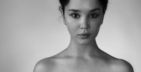 Natural beauty closeup. Black and white portrait of a young girl without makeup with Clean youthful skin.の写真素材