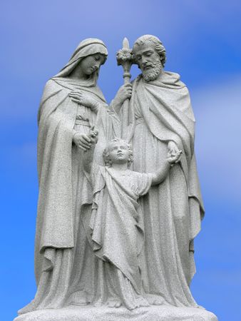 A religious scuplture with a blue sky background.の写真素材