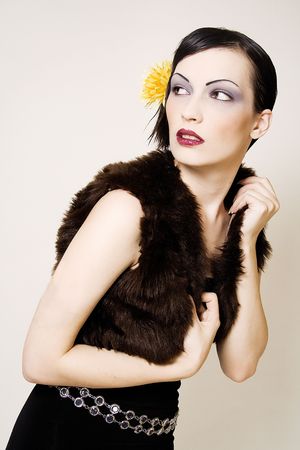 A woman pulling up her fur coat.