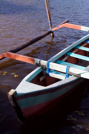 Colorful Asian fishing boat in calm lakeの写真素材