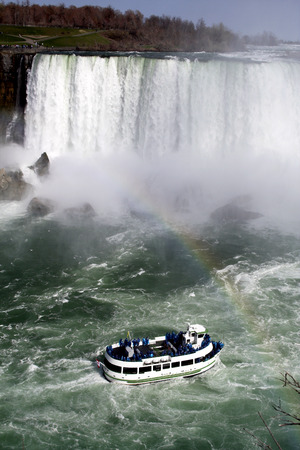 Lovely view of Niagara Falls with boat and rainbowの写真素材